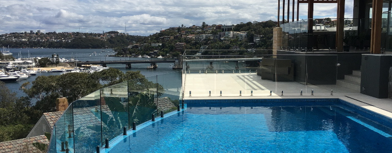 frameless glass pool fencing on a modern home